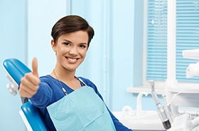 Happy dental patient making thumbs up gesture