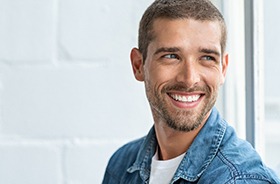 Smiling, handsome man enjoying benefits of dental bridges