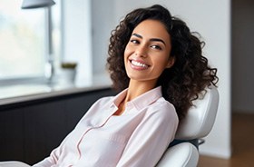 Smiling woman with beautiful teeth in dental treatment chair