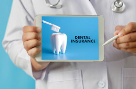 medical professional holding tablet with dental insurance information