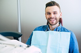 Smiling man at checkup for his dental implants in Hamden