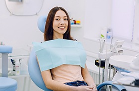 Smiling patient sitting upright in dental treatment chair