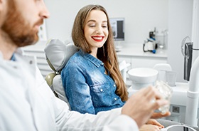 Smiling patient listening to dentist explain something