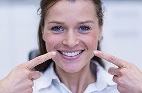 Woman pointing to repaired smile