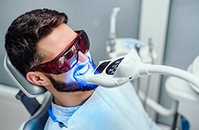 Man undergoing in-office teeth whitening treatment